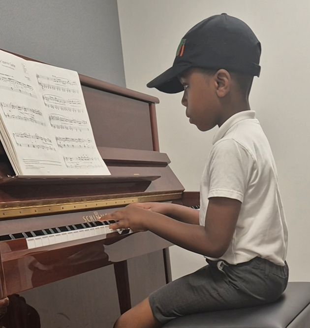 photo of child at piano